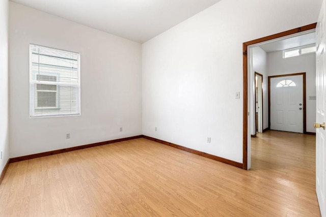 empty room with light hardwood / wood-style floors and a wealth of natural light