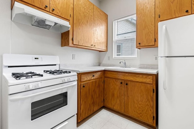 kitchen featuring white appliances and sink