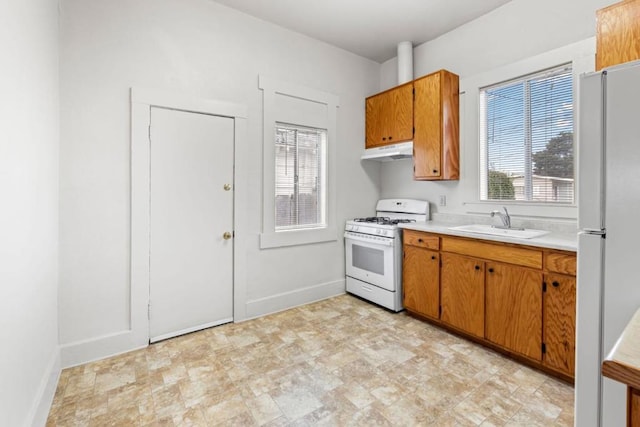 kitchen featuring white appliances and sink