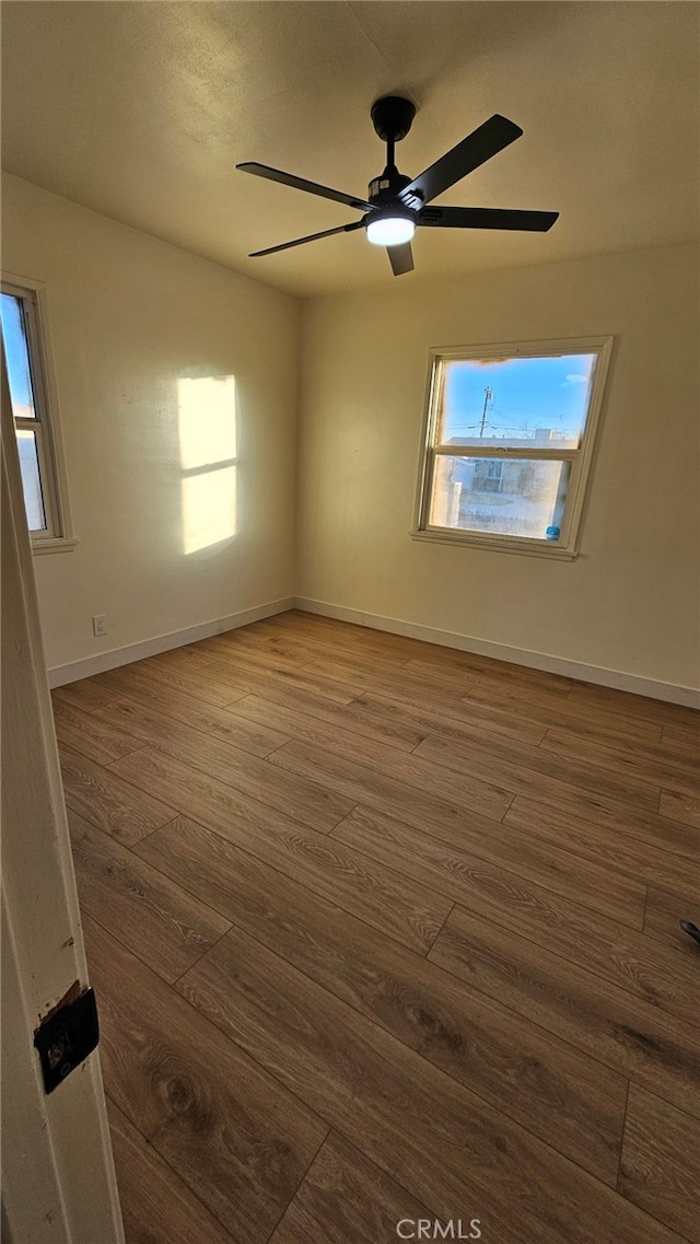 unfurnished room featuring ceiling fan and dark hardwood / wood-style flooring