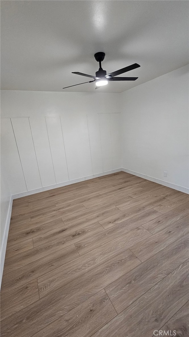 spare room featuring ceiling fan and light hardwood / wood-style floors