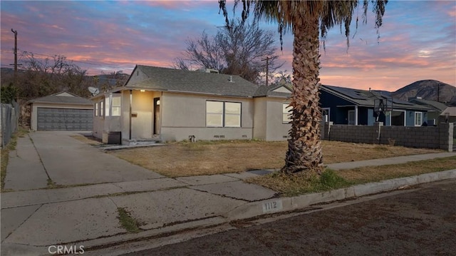 view of front of property with a garage and an outdoor structure