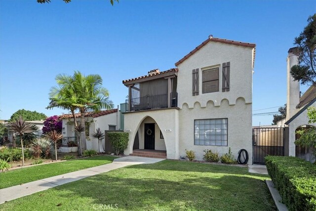 mediterranean / spanish home featuring a front yard