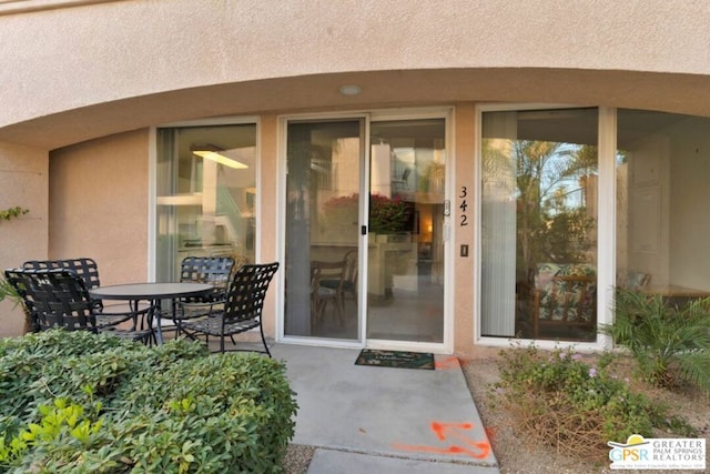 property entrance featuring a patio area