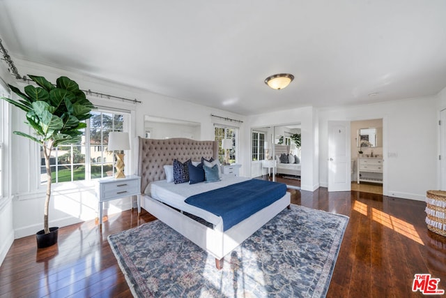 bedroom with dark hardwood / wood-style flooring