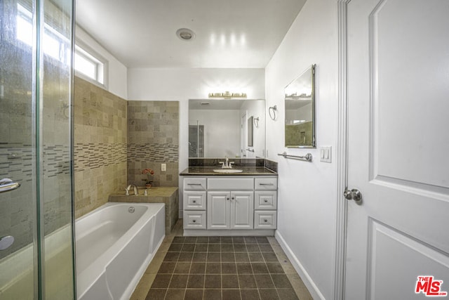 bathroom with a tub and vanity