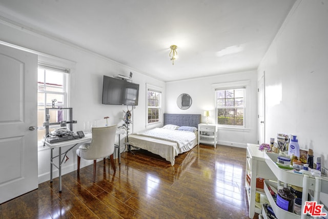 bedroom with multiple windows, dark hardwood / wood-style flooring, and crown molding