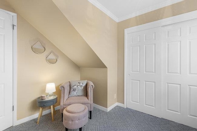 sitting room with ornamental molding and carpet flooring