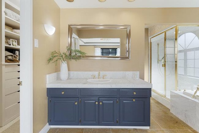 bathroom featuring plus walk in shower, tile patterned floors, and vanity