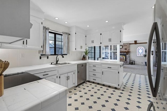 kitchen with stainless steel appliances, white cabinetry, and kitchen peninsula