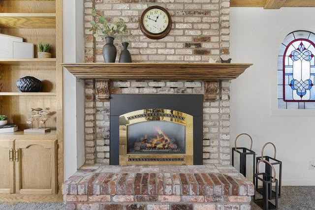 interior details with a brick fireplace and carpet