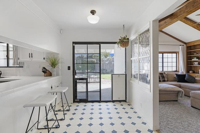 entryway with lofted ceiling with beams