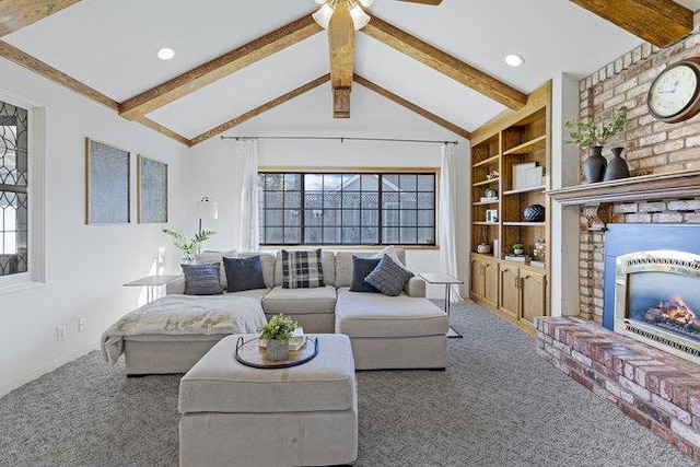 living room featuring carpet flooring, lofted ceiling with beams, a healthy amount of sunlight, and built in features