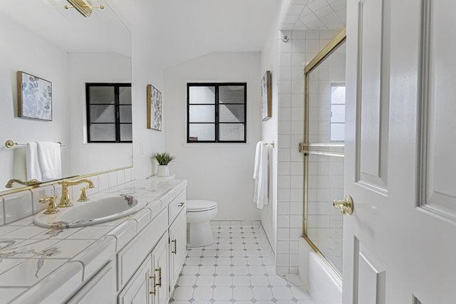 full bathroom featuring toilet, vanity, and combined bath / shower with glass door