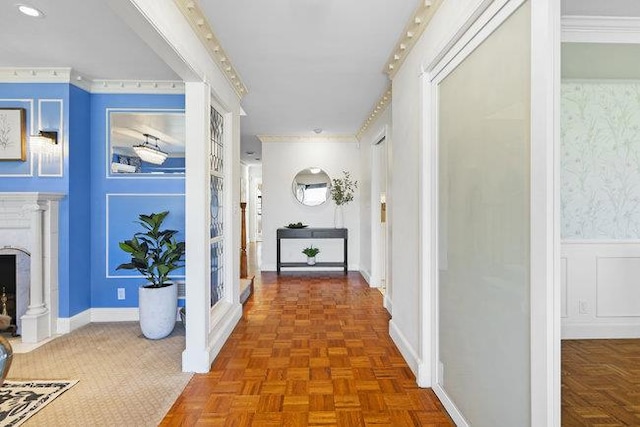 hall with dark parquet flooring and crown molding