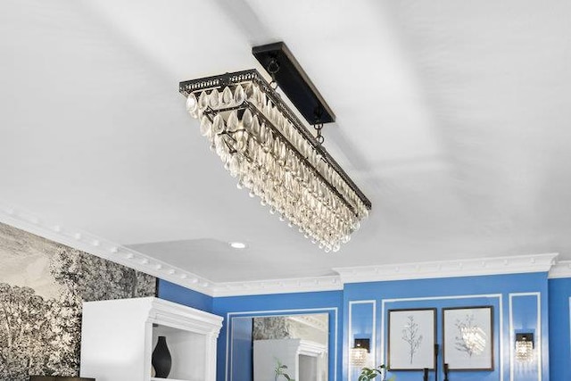 details with an inviting chandelier and crown molding