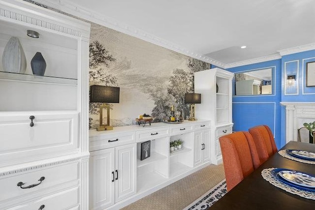 bar with white cabinets and ornamental molding