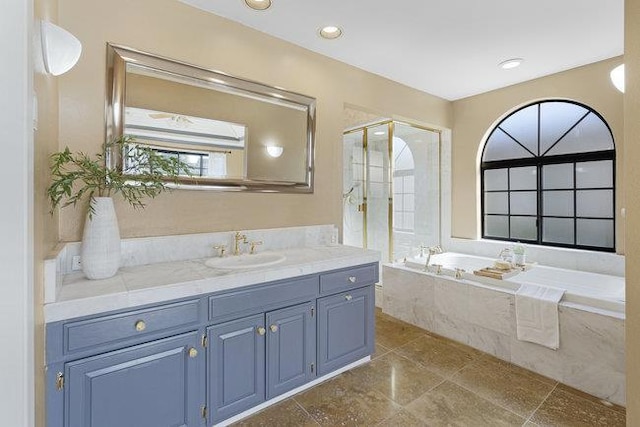 bathroom featuring independent shower and bath and vanity