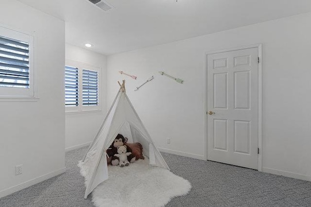 rec room with light colored carpet