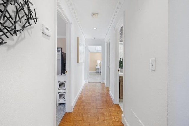 hall featuring light parquet floors and crown molding