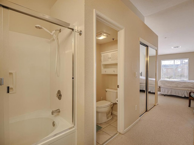 bathroom with shower / tub combination, toilet, and tile patterned floors