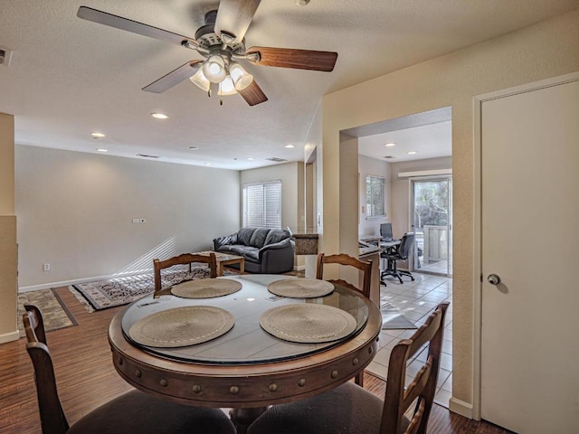 tiled dining room featuring ceiling fan