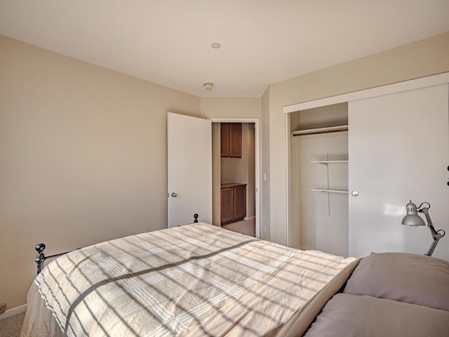 bedroom with carpet and a closet