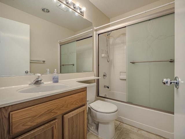 full bathroom with tile patterned floors, vanity, toilet, and shower / bath combination with glass door