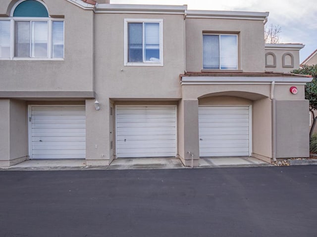 multi unit property featuring a garage