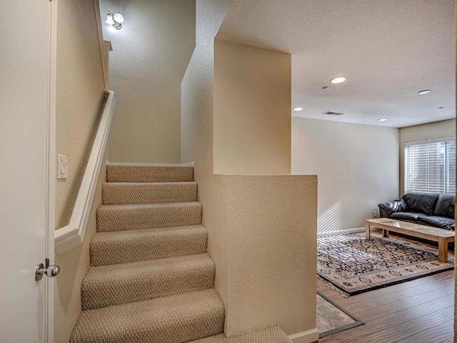 staircase with hardwood / wood-style flooring