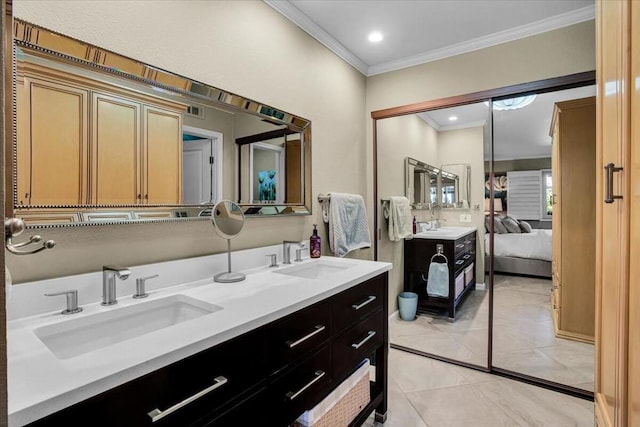 bathroom featuring tile patterned flooring, crown molding, and vanity