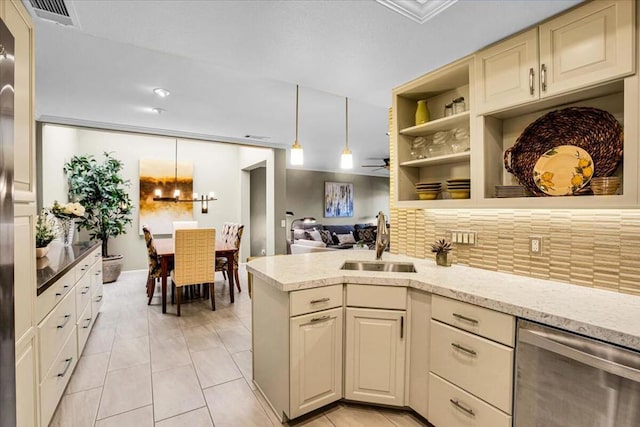 kitchen with sink, hanging light fixtures, cream cabinets, ceiling fan, and stainless steel dishwasher