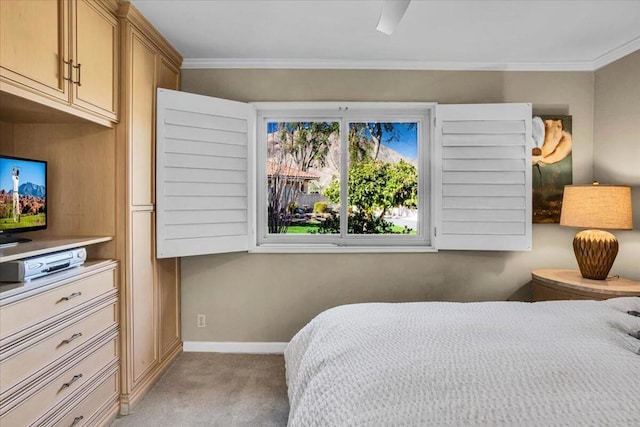 carpeted bedroom featuring ceiling fan and crown molding