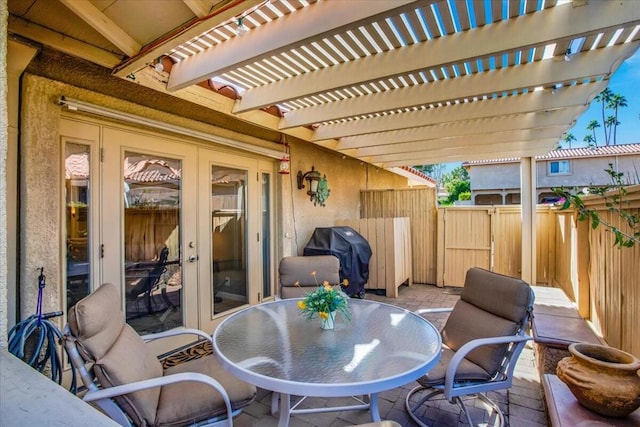 view of patio featuring area for grilling and a pergola