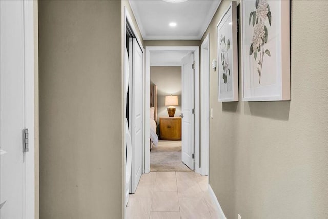 hall featuring crown molding and light carpet