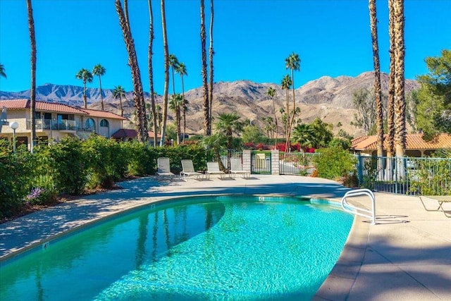 view of swimming pool featuring a mountain view and a patio area