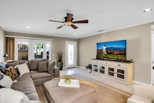 living room with ceiling fan, crown molding, and french doors