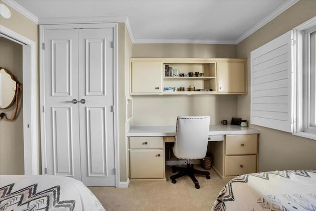 carpeted bedroom featuring a closet, ornamental molding, and built in desk