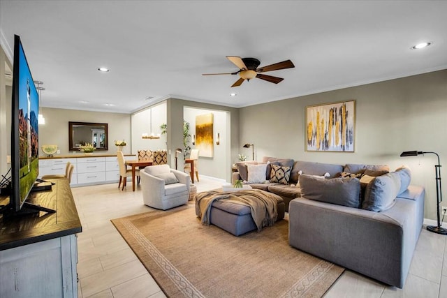 living room featuring ceiling fan and ornamental molding