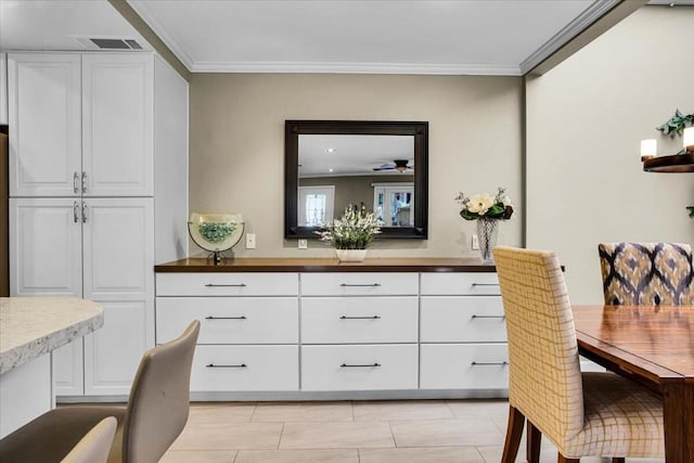 dining space with ornamental molding