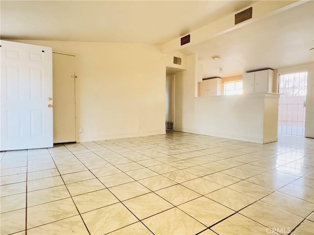 spare room featuring lofted ceiling