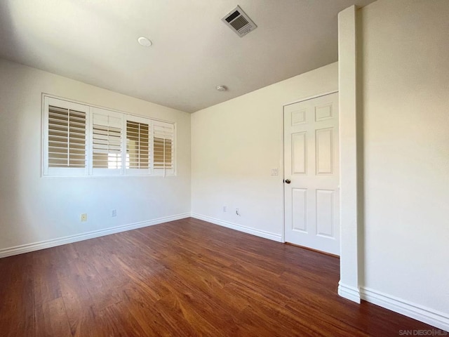 unfurnished room featuring dark hardwood / wood-style flooring