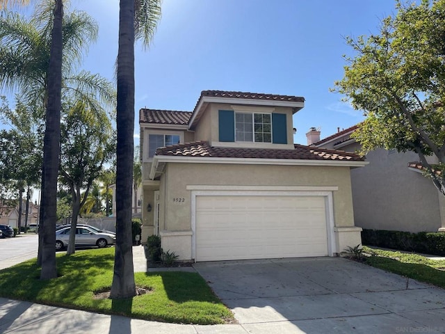 mediterranean / spanish house with a front yard and a garage