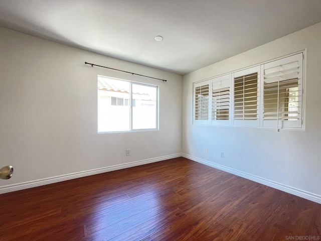 empty room featuring dark hardwood / wood-style flooring