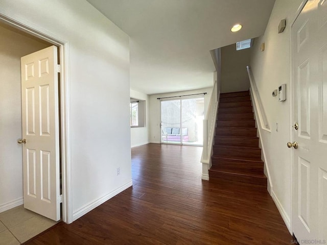 staircase featuring wood-type flooring