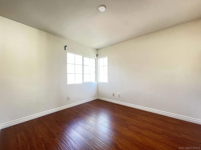 empty room with dark hardwood / wood-style floors