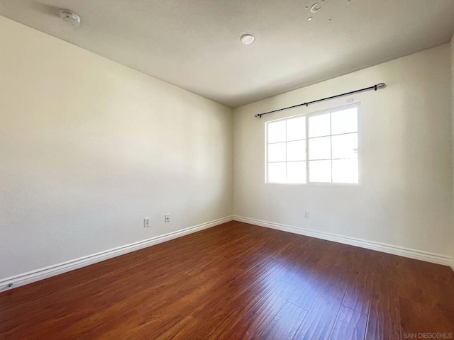 empty room featuring dark hardwood / wood-style flooring