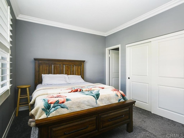 bedroom featuring a closet, ornamental molding, and dark colored carpet