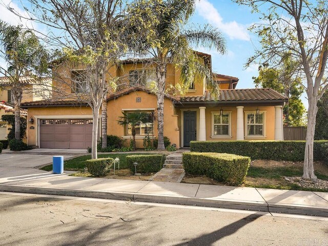 mediterranean / spanish-style house with a garage