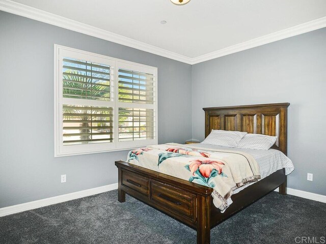 bedroom with carpet floors and crown molding